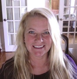 A woman sitting in front of a window.