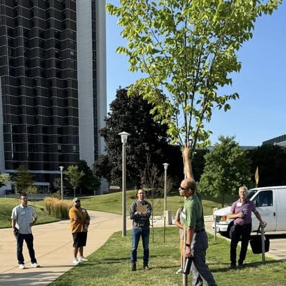 People gathered outdoors near a tall building.