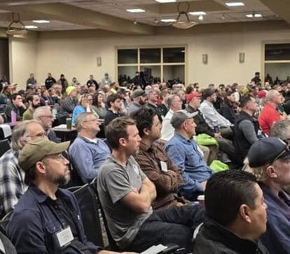 Audience attentively listening at a conference.