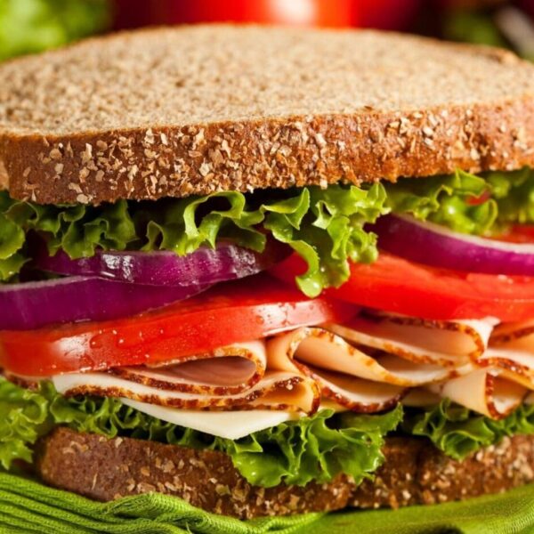 Whole grain sandwich with lettuce and turkey.