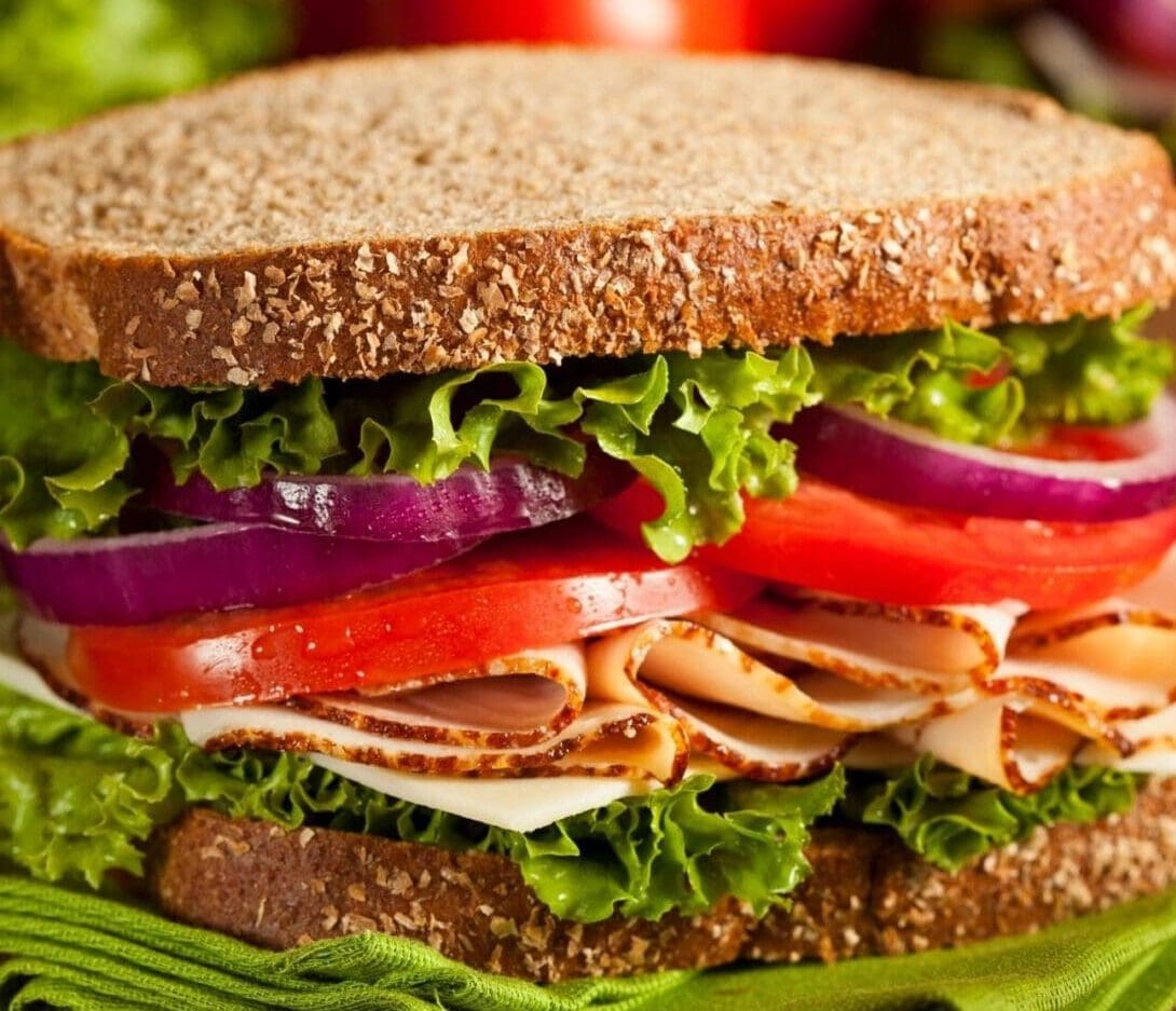 Whole grain sandwich with lettuce and turkey.