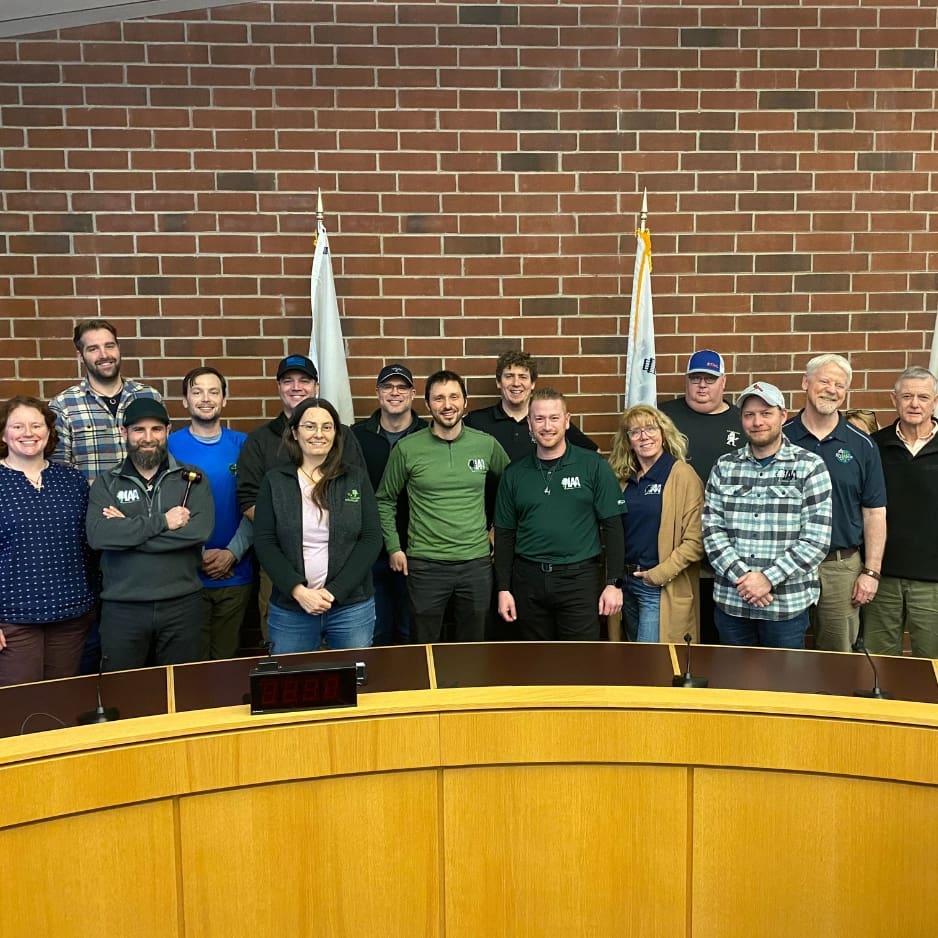 Board members standing behind council dais