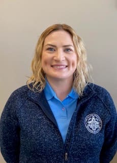 Smiling person in a blue jacket.